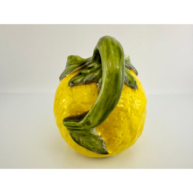 This is a beautiful ceramic pitcher with bright yellow and green colors. The piece is not marked but the owner acquired in...