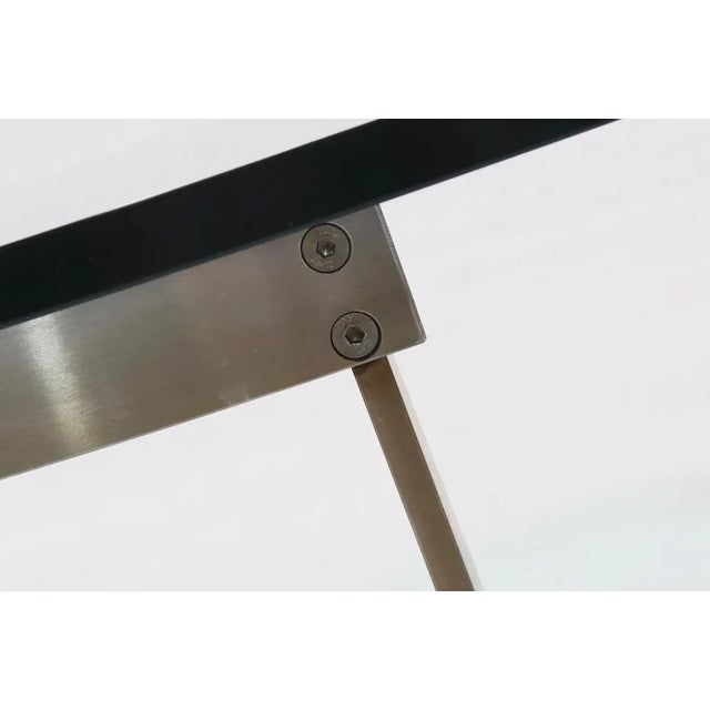 G3 coffee table designed by just van beek for Metaform in the 1980s. The table has a stainless steel base with trapezium...