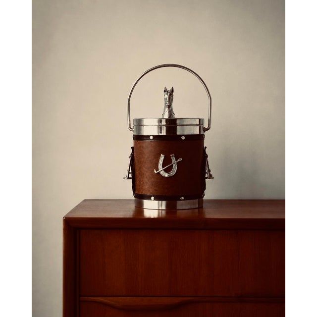 A striking english equestrian ice bucket dating from the 1970s, combining classic vintage barware with a bold and highly...