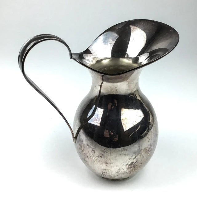 Freshly POLISHED, A very unique design we have here. The first 2 photos are of the pitcher after polishing. This beauty is...