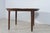 This Mid-Century Danish dining table was designed by Ole Hald and manufactured by Gudme Møbelfabrik. It is characterized...