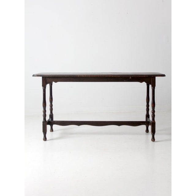 This is an antique Victorian console table. The wooden sofa table has a dark finish with turned legs and a decoratively...