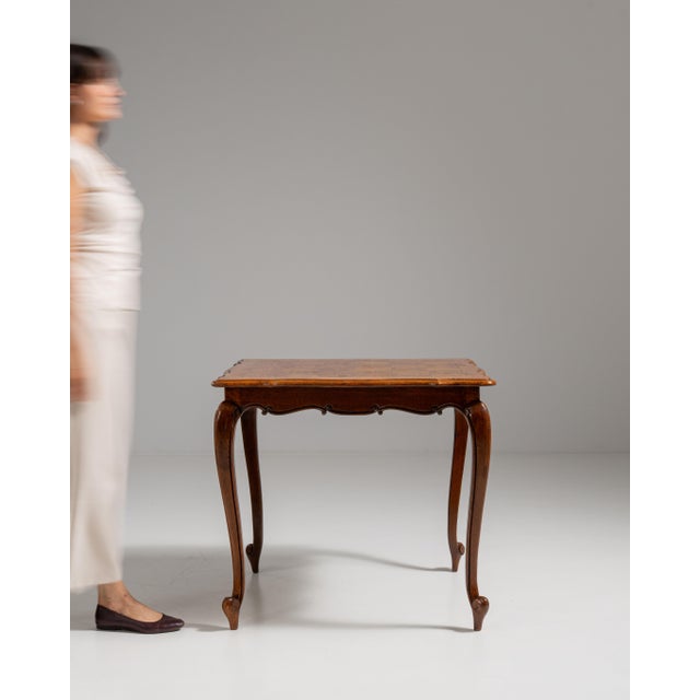 This 19th century Louis XV oak side table from France is made in dark fruitwood with a square top and gracefully curved...