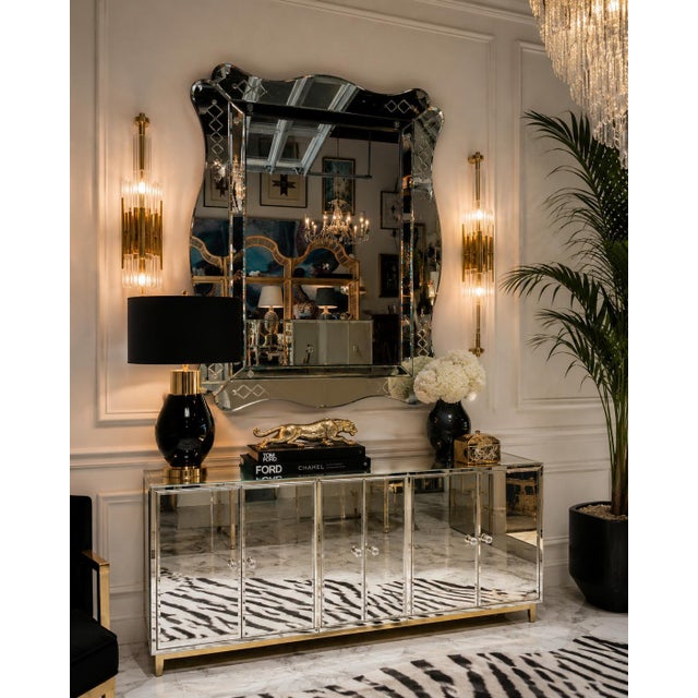 A striking Italian Hollywood Regency wall mirror from the 1960s, featuring an elegant scalloped silhouette, beautifully...