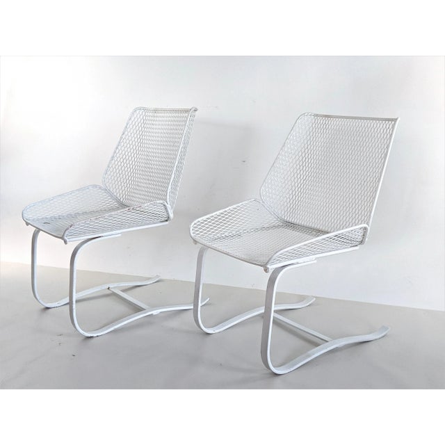 Pair of vintage cantilever bouncer patio chairs. Unusual "shovel" design; In the style of Woodard or Salterini. Very...