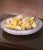 Bring a refined decorative touch to a tabletop or kitchen display with this charming set of sixteen hand-carved stone...