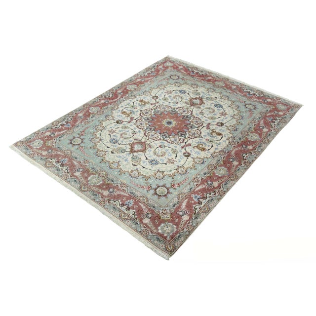 This high quality Tabriz rug is an excellent example of traditional craftsmanship. The fine 50 Raj knotting in combination...