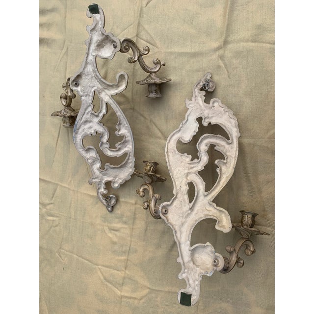 Pair of French style, double-arm candle wall sconces; Brass painted cream and gold; Sturdy arms; These are in very good...