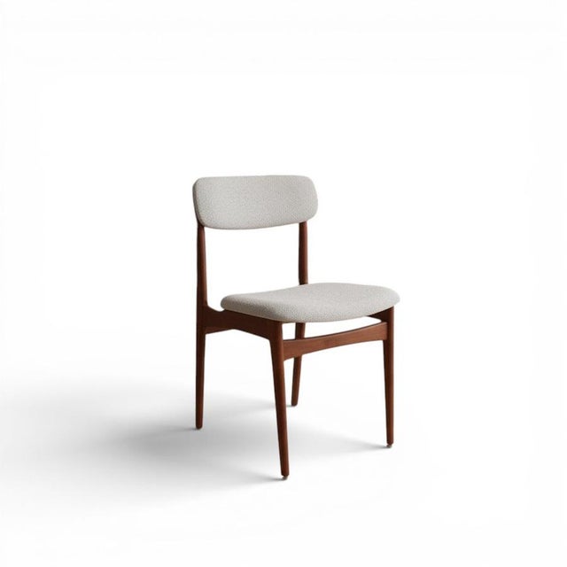 Danish neat and elegant chair in teak with a golden brown tone! The chair has a seat and front back upholstered in a...
