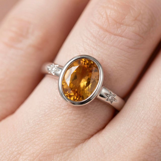 Delicate yet radiant, this elegant ring showcases a warm and luminous Citrine gemstone, designed to bring a touch of...