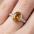 Delicate yet radiant, this elegant ring showcases a warm and luminous Citrine gemstone, designed to bring a touch of...