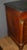 Empire-style walnut commode with a half-column top and a Belgian Granité marble top. It features four drawers and its...