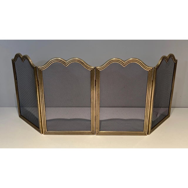 This rare neoclassical style 4 panel fireplace screen is made of brass and chicken wire. This is a French work. Circa 1970