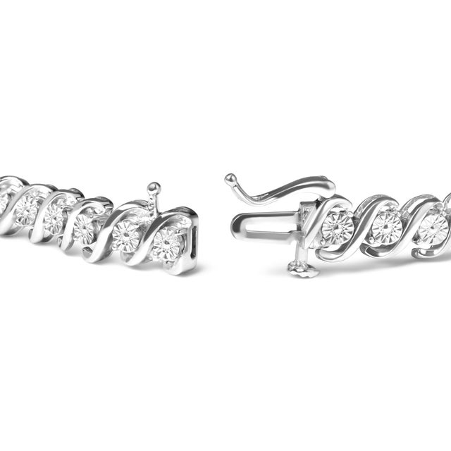 Indulge in the delicate beauty of this .925 Sterling Silver 1/4 Cttw Miracle Set Diamond and Beaded 7.25" Tennis Bracelet....