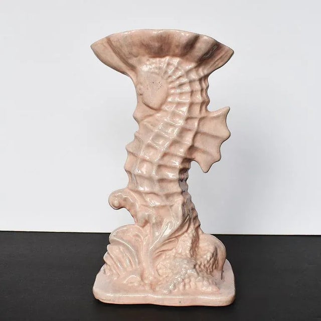 Tall Hollywood Regency style pink imperial line vase in the shape of a seahorse. This eye catching vessel is tall in form,...