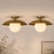 Crafted from solid brass and paired with a softly diffused opal glass globe, this flush mount ceiling light offers a...