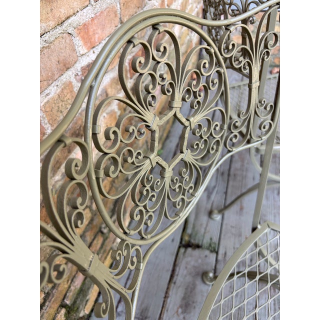 highly desirable set of older Andalusian iron occasional chairs, redone in soft oregano circa 1960s each has a scrolled...