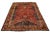 This exquisite Persian Shiraz hand-knotted wool rug features a rich red field elegantly embellished with golden and...