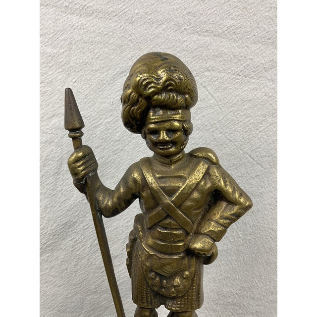 Antique brass Figural Highlander with appropriate outfit including kilt, sash, purse,headgear and staff. Nice detailing of...