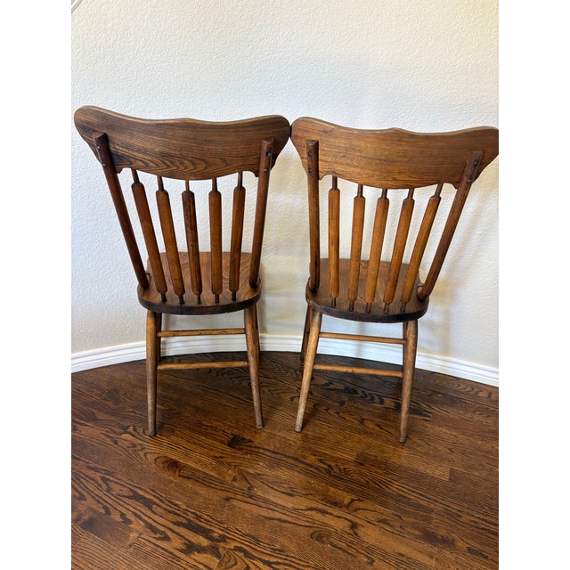 Celebrate the craftsmanship of turn-of-the-century American furniture with this handsome pair of Late Victorian pressed-...