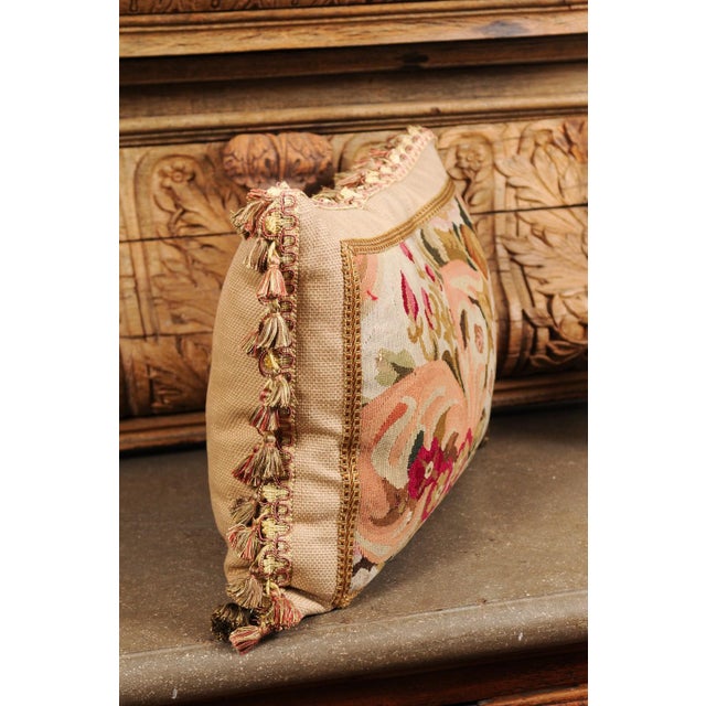 A pillow made from 19th century French tapestry, with floral décor and tassels. Crafted from a tapestry woven during the...