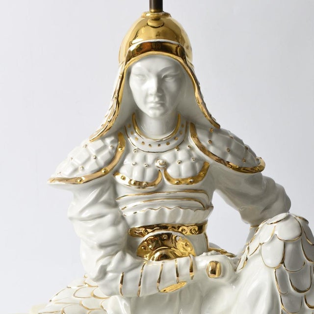 Figural ceramic table lamp is shape of a sitting samurai. Partially gold plated. Made in Italy in 1970s. Dimensions...