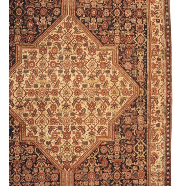 An elaborately woven 19th century Persian Bibikabad runner with large central diamond medallion with a floral lattice...