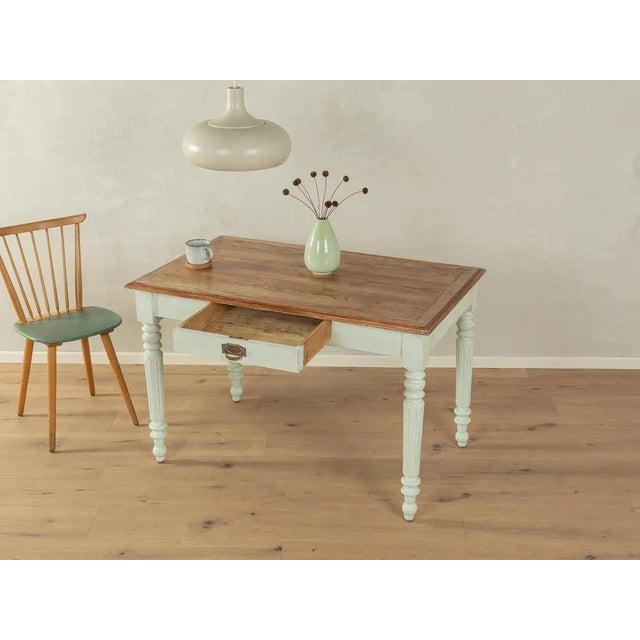 Magnificent dining/desk from the 1930s. Mint green lacquered solid ash wood frame with one drawer and a table top with...