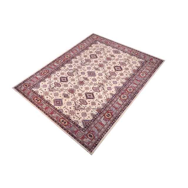 Enhance your home with this exquisite hand-knotted Super Kazak rug, crafted from fine hand-spun wool and dyed with all-...