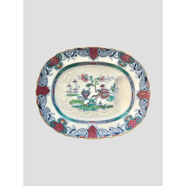 This beautiful export antique meat platter was produced in China. Depicting a lovely chinoiserie scene. Colorful florals...
