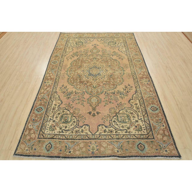 An authentic vintage traditional Tabriz rug hand-knotted with an all-wool pile on a cotton foundation. This oriental rug...