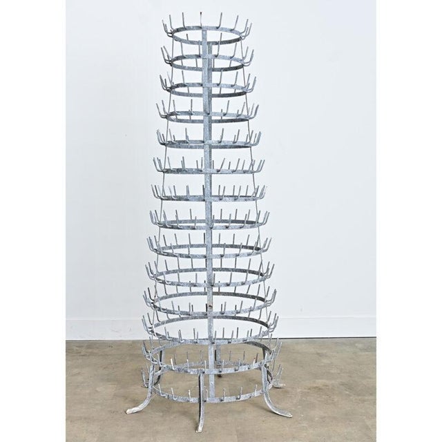 A massive French wine/beer bottle drying tree from circa 1920 in zinc plated metal. The spiky, conical form (also called a...