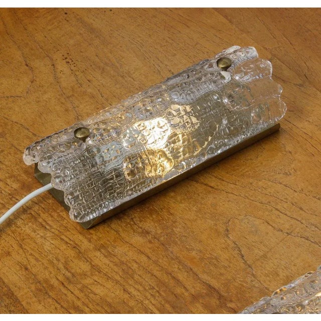 Set of two beautiful scones / wall lights designed by Carl Fagerlund for Orrefors, Sweden, 1960s. Both scones are in...