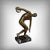 A bronze sculpture with a brown patina depicting the famous Discobolus, attributed to the Greek sculptor Myron, captures...