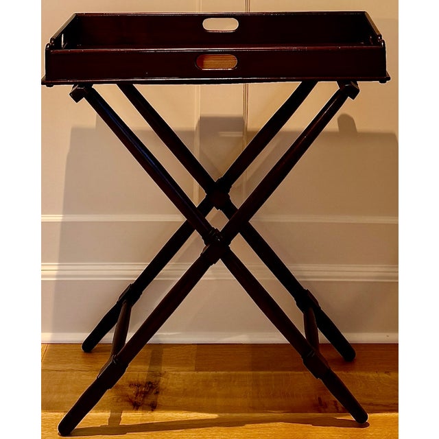 A handsome late 19th century English mahogany butler’s tray on stand, dating to circa 1890. This versatile table features...