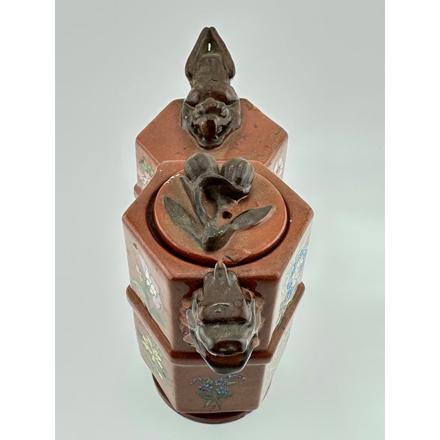 Antique Watcombe pottery teapot by Christopher Dresser featuring brown terracotta finish with floral details. This is a...