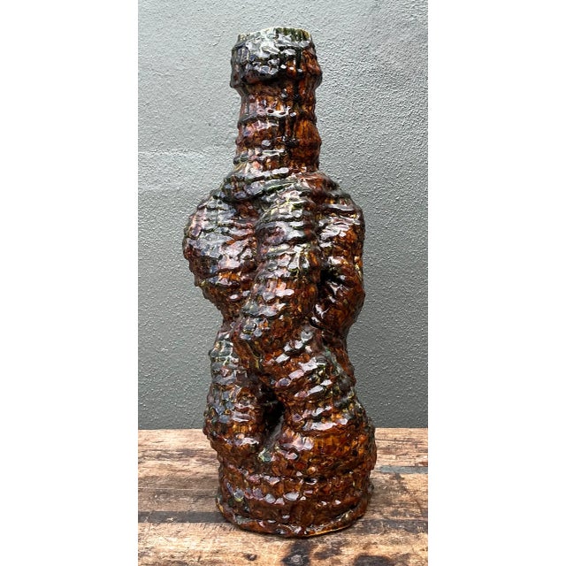 This vintage sculptural ceramic vase brings mid-century modern character to a room through its richly textured surface,...
