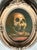 This compelling 20th-century oil painting captures the haunting beauty of a classic memento mori subject. Rendered on...