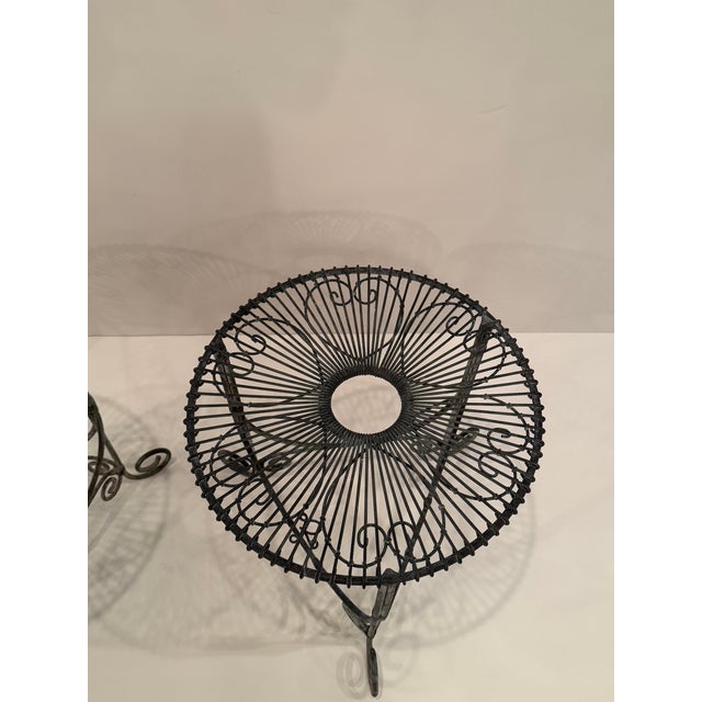 Stylish pair of French metal wire side tables having lovely pattern on top and curlicue legs. RR
