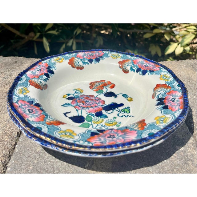 Two multi color salad plates by Wood & Sons (England). Cobalt edge with maroon and pink florals trimmed in gold.