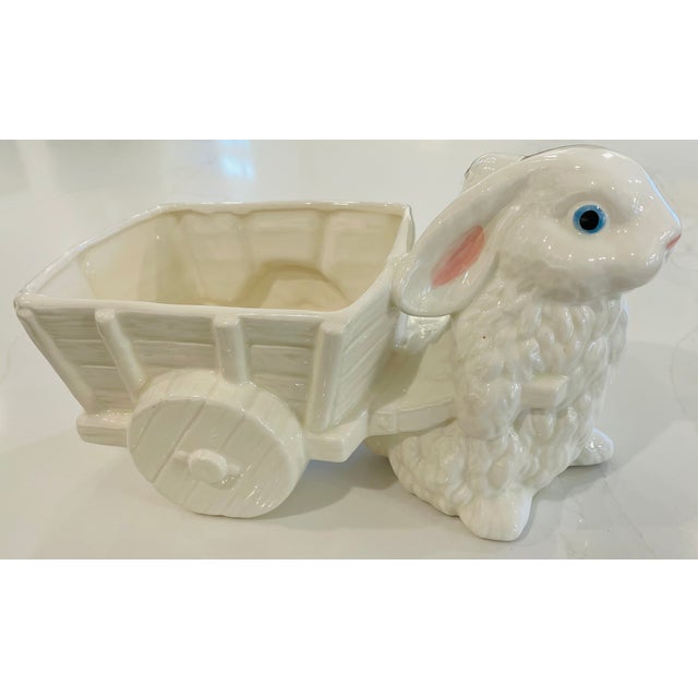 This charming vintage ceramic planter features a sweet white rabbit pulling a decorative cart. Beyond plants, this...