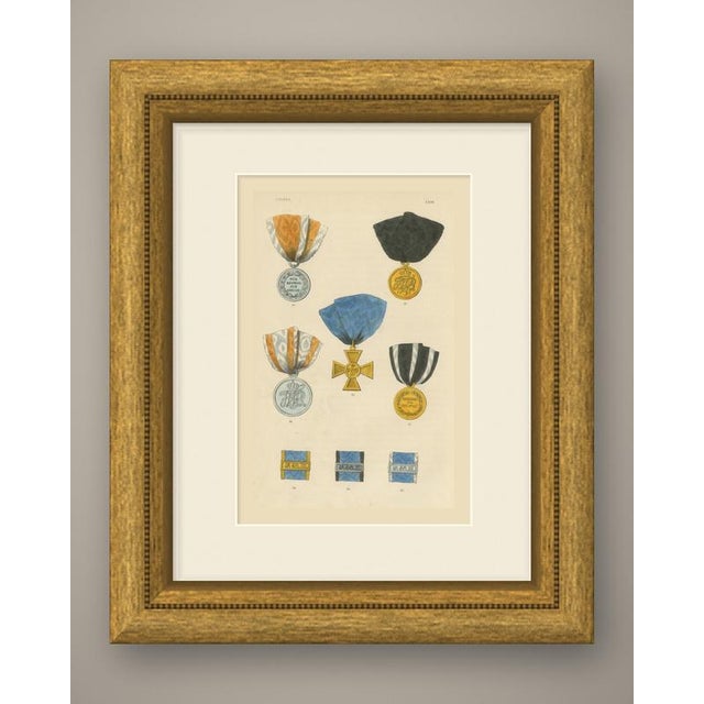 This is an original antique wood engraving, colored by hand, showing medals and service decorations of prussia. At upper...