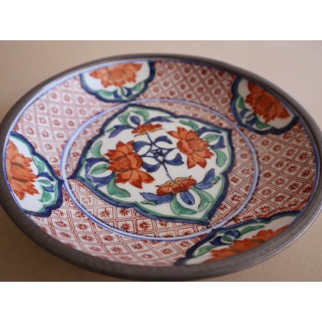 Vintage Imari style dish encased in pewter made for Neiman Marcus. Hand painted lattice pattern and blossoms.