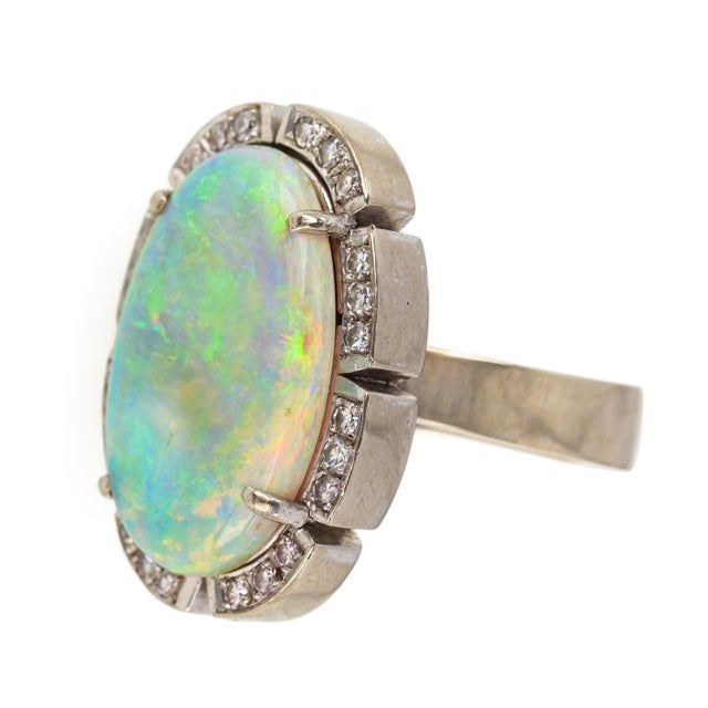 Vintage 18k White Gold Ring set with a polished Australian Opal and Diamond Cocktail Ring. The impressive center opal is...
