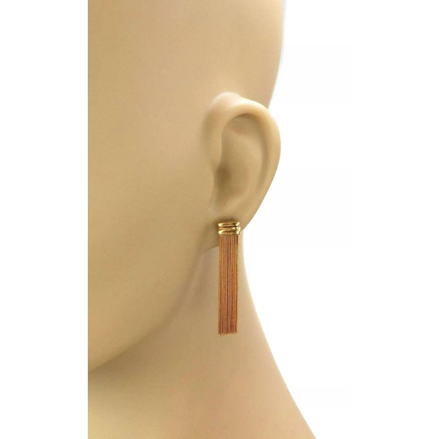 This is a beautiful pair of dangle earrings, they are crafted from 18k yellow gold with a polished finish. The pair...