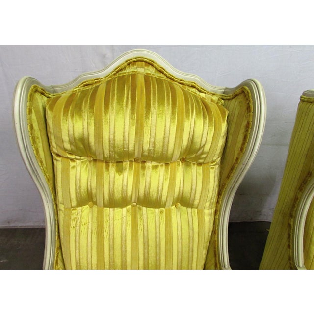 Pair of Hollywood Regency parlor chairs. The style's trademark combination of a simplified revival frame, in this case...
