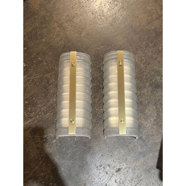 Pair of modern Murano ribbed glass and brass barrel sconces. Perfect for today's transitional designs!