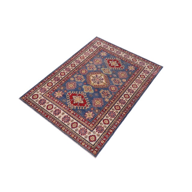 Enhance your home with this exquisite hand-knotted Kazak rug, crafted from fine hand-spun wool and dyed with all-natural...