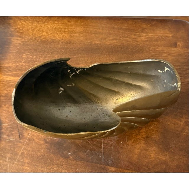 "Hari brass nautilus shell" refers to a type of vintage solid brass nautilus shell sculpture or planter, often used as...