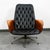 This molded ply lounge chair by George Mulhauser features stylish wing-like arms, tufted vinyl, and metal swivel base. The...